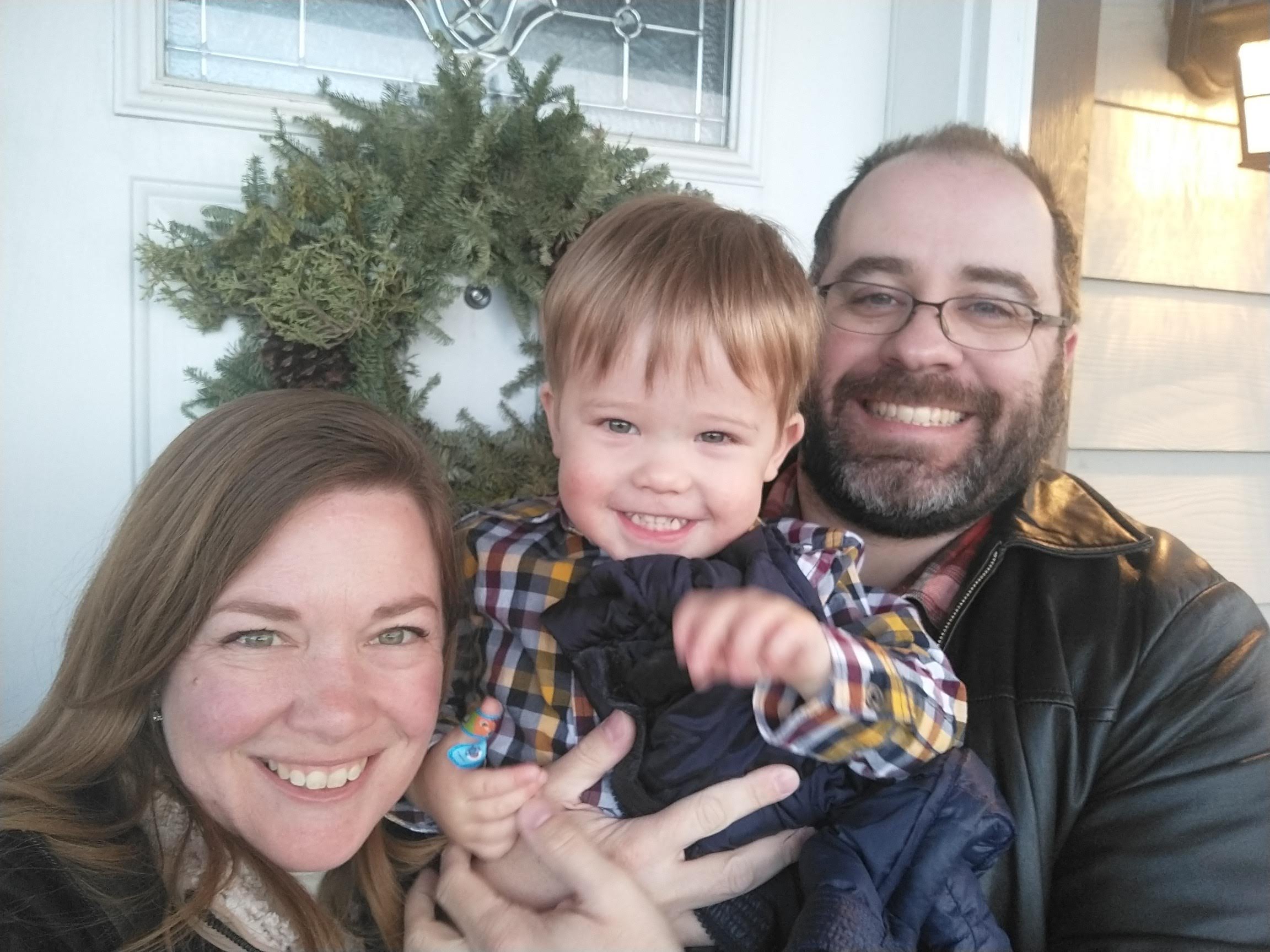 Kelly, Alexander, and Phil in front of their front door